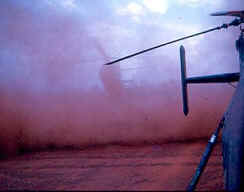 reddish cloud of dust behind helicopter