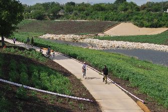 Summer visitors enjoy walking and biking along the completed pathways. When completed the Mission Reach Ecosystem Restoration and Recreation Project will be eight miles in length, restoring the previously channelized San Antonio River closer to its original state, while maintaining its role as a flood risk management area. (Photo by Edward Rivera)