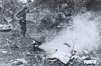 Engineers unpack and test a Mitey-Mite blower in the Vietnamese jungle