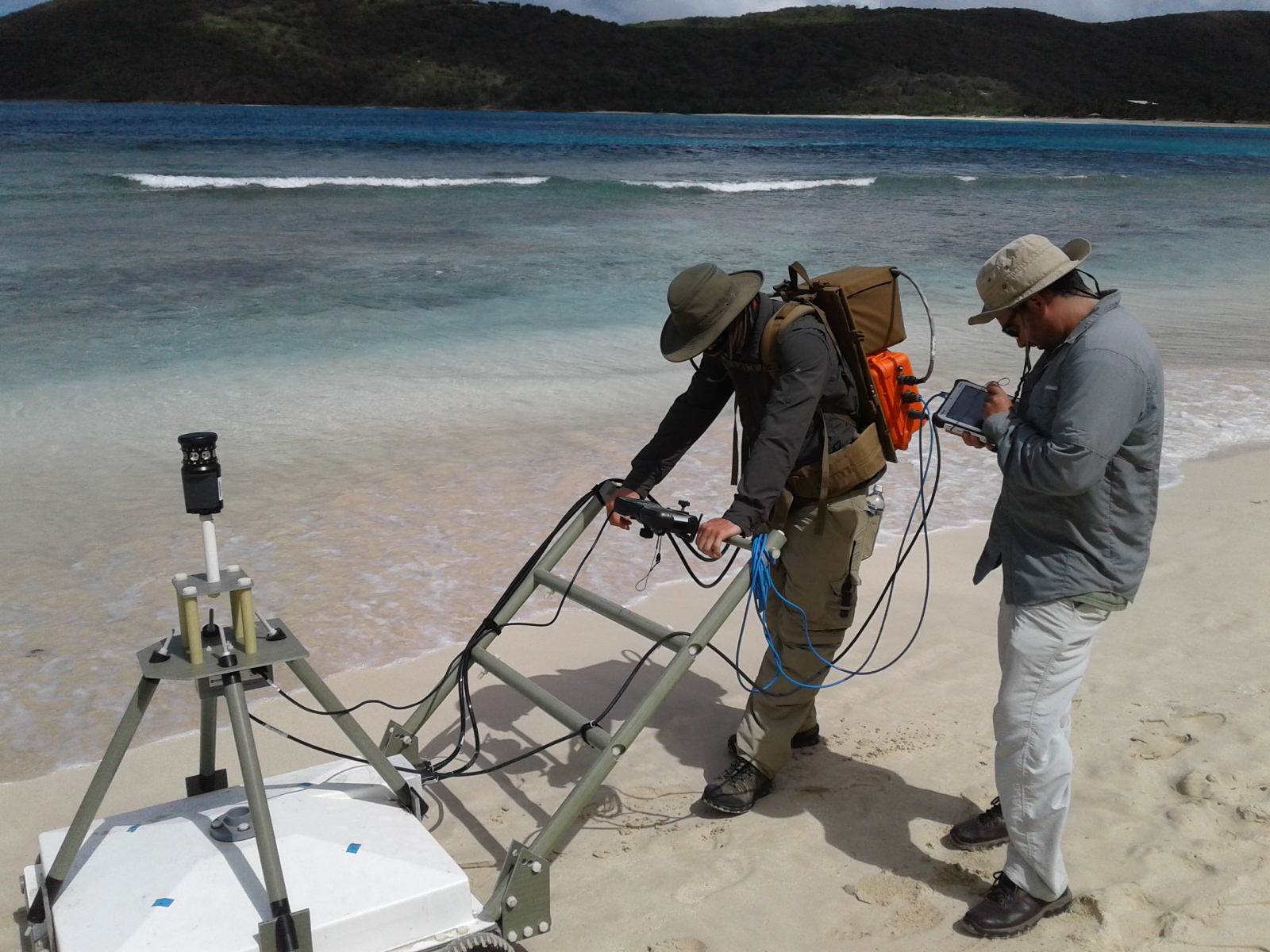 Workers use advanced geophysical classification to identify unexploded ordnances as part of the Time Critical Removal Action on Culebra Island in Puerto Rico. Advanced geophysical classification uses the natural properties of a buried metal to determine if the object is a target of interest. It will reduce the overall time and cost of remediation activities within the Formerly Used Defense Sites program. (Photo courtesy of HydroGeoLogic Inc.)