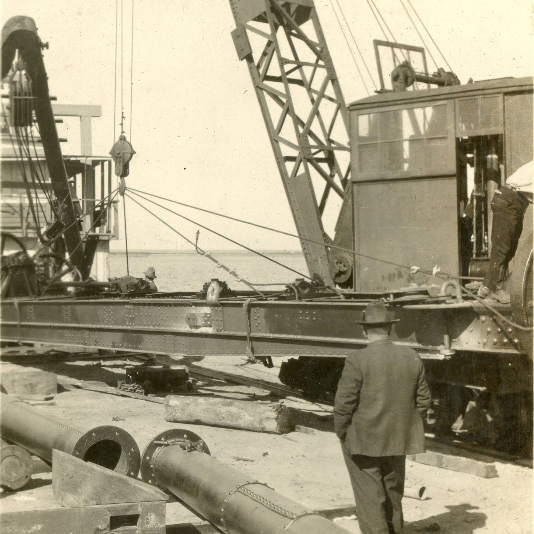 Man on a dock with crane and machinery nearby