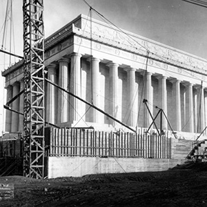 Angled view of the columns of the Lincoln Memorial and construction equipment