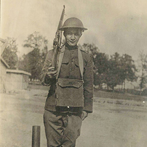 Young male soldier in uniform with rifle