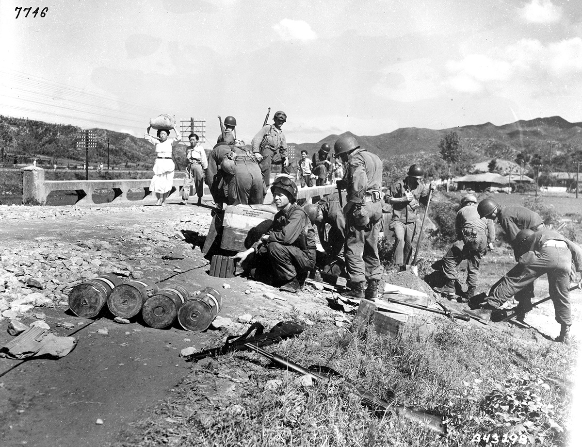 soldiers mine a bridge over a culvert as civilians pass over it soldiers mine a bridge over a culvert as civilians pass over it