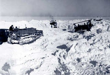Bulldozers moving piles of snow
