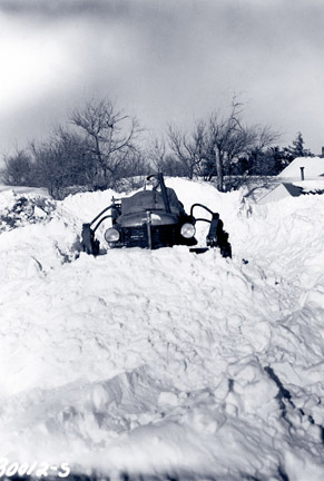 snowmobile-like tractor on snow dune