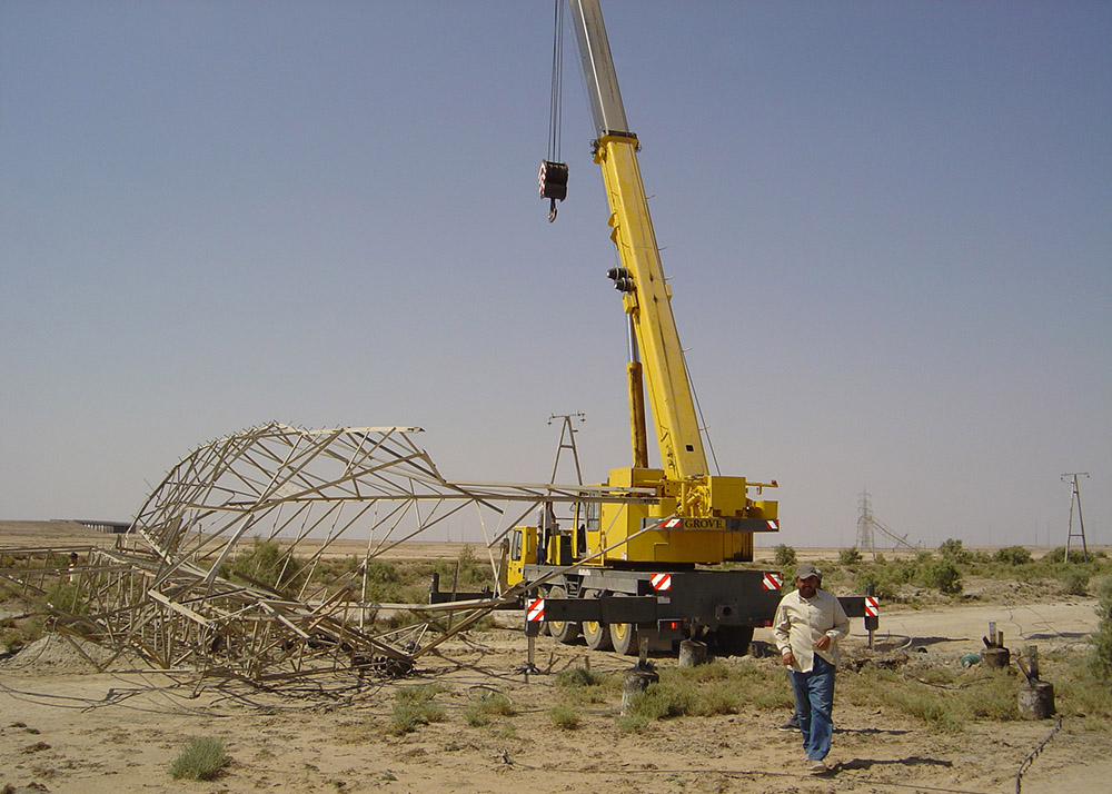 electrical tower crumpled on barren ground